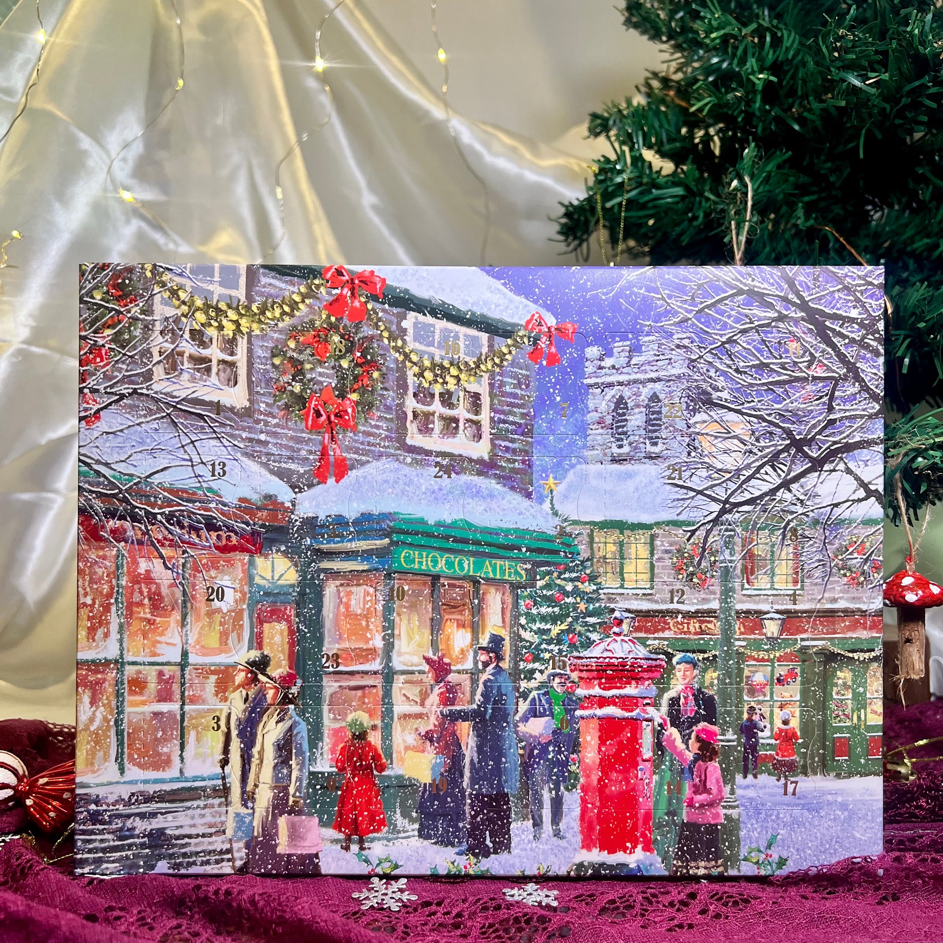 Christmas-themed advent calendar with snowy village scene